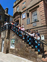 a group of students standing on stone stairs
