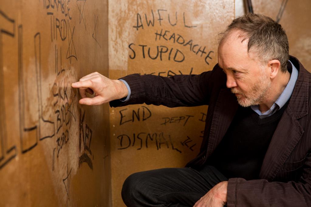 Speaker John Schofield, inspecting Sex Pistols graffiti and artworks, at 6 Denmark Street, London. (Photo: Ian Martindale) 