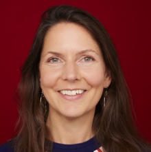 Dr Melanie Van de Velde profile photo against a red background