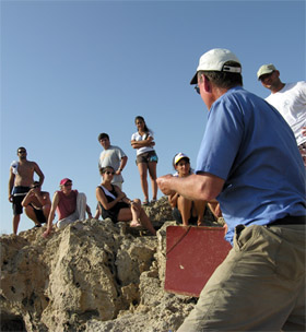 Bernard Knapp (3rd from left) and others listen to Albert Ammerman at the Late Epipalaeolithic/Early Aceramic Neolithic site of Nissi Beach, Cyprus