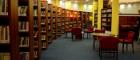 Library with rows of bookshelves arranged in an arc and a study area
