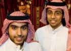Saudi students Saif Al Ghandi and Abdullah Al Owaifeer at the Glasgow Saudi Student Club cultural exhibition, wearing traditional thawb garments.