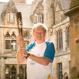 Dr Des Gilmore with baton on Campus July 21 2014