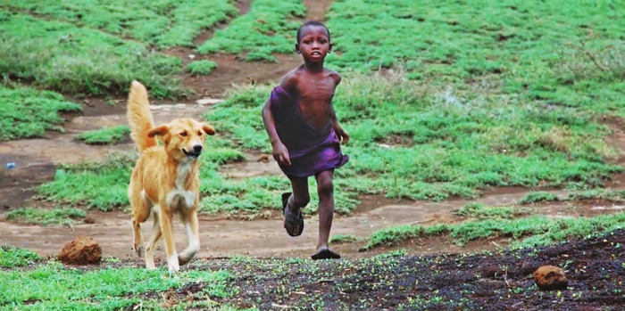 Boy with dog in Tanzania. Credit Katie Hampson