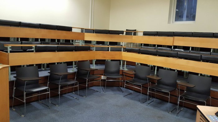 Raked lecture theatre with fixed seating and chairs