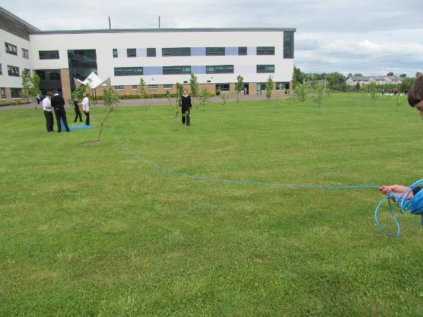 Pupils from Crieff High School laying out the route of Broich cursus, which underlies the school, ditch using blue ropes