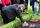 Image of a cross being planted in the garden of remembrance