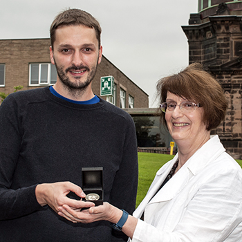 Image of Ewan Fitzsimons being awarded with his STFC award by Director Professor Gillian Wright