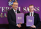 The signatories of the Memorandum of Understanding between UofG and the Universiti Sains Malaysia, shaking hands.