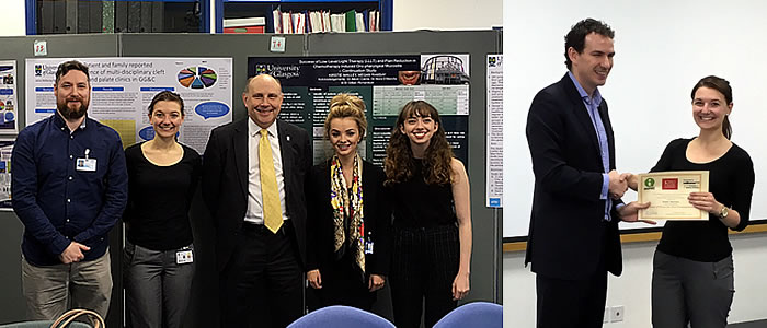 Students in front of posters and receiving award