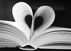 A book with two pages turned in to form a heart