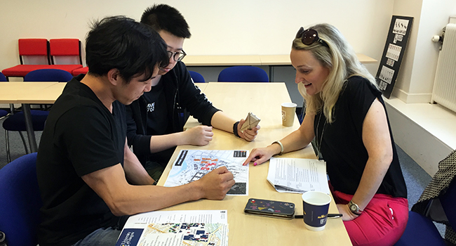 Image of international students chatting with Estates and Buildings Assistant Director, Nicola Cameron.