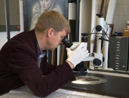 Dr Mark Richter carries out examination with a stereomicroscope of the El Greco Portrait of a Gentleman in the Stirling Maxwell Collection for comparison with the Lady in a Fur Wrap (pictured behind). © CSG CIC Glasgow Museums Collection.