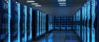 Image of many data servers in a brightly lit server room
