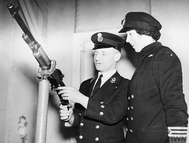 2nd Engineer Miss Victoria Drummond, MBE, MN, receiving instruction on components of a machine gun. © IWM (A 7841A)