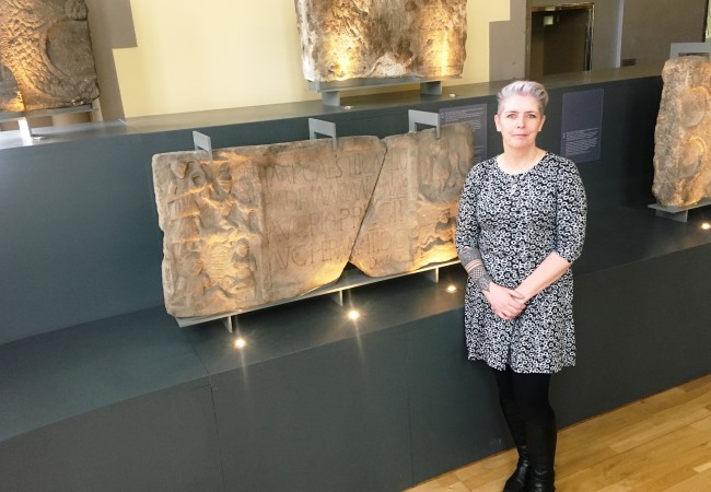 Dr Louisa Campbell in The Hunterian with  one of the Roman stones she examined for paint pigment