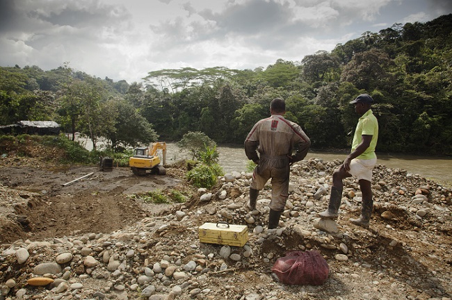 A photo of the Colombia River Stories project featuring people mining on a river 