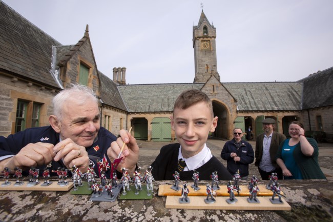 Robert McCreadie (right) from Dumbarton, a Royal Navy veteran & S3 pupil Calan Mulgrew, Clydebank High School inspecting some of the 28mm figures which will take part in The Great Game: Waterloo Replayed. Background (l to r)  – Steve Wyllie, an Army veteran i; Professor Tony Pollard & Evonne McCord, Activities Co-ordinator at the Erskine Activities Centre. Photo Credit Martin Shields