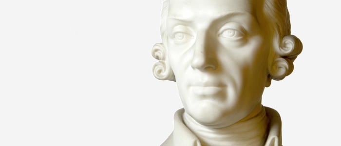 Adam Smith statue on white background