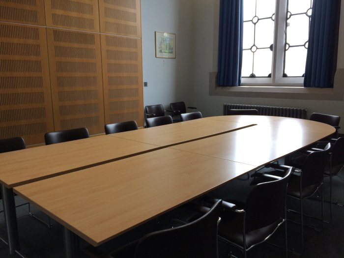 Flat floored meeting room with boardroom table and chairs
