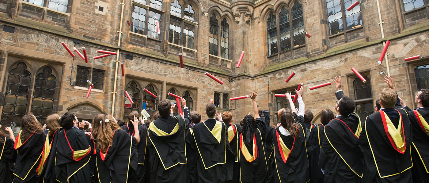 Graduates throwing their scrolls [Photo: UofG]