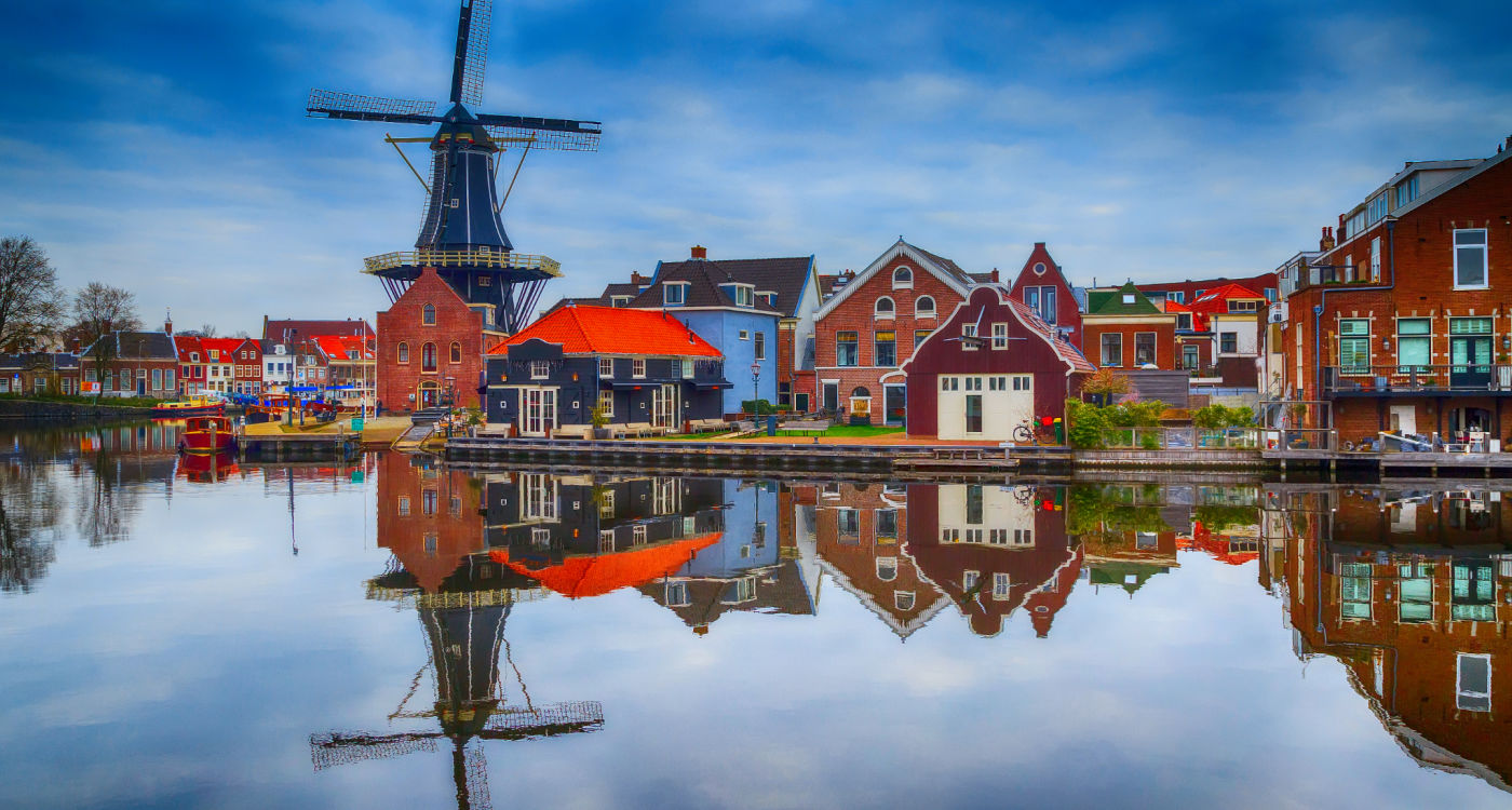 Windmill and traditional houses in Haarlem, the Netherlands [Photo: Shutterstock]