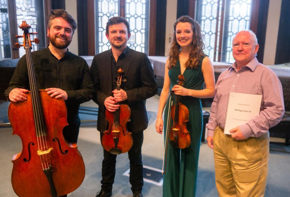 Composer Eddie McGuire with the performers and score of String Trio II following its premiere