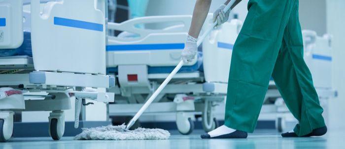 Image of a woman with a mop cleaning a floor