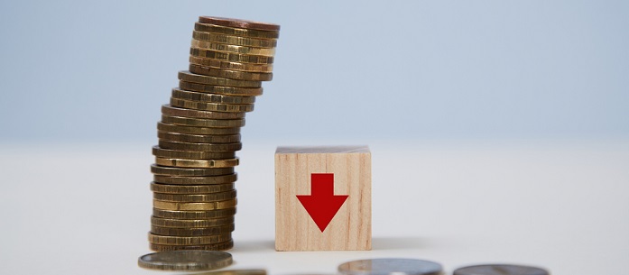 Stack of coins next to a red arrow pointing down