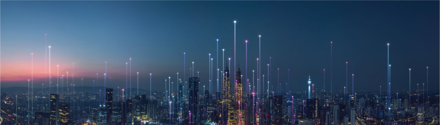 Abstract image of a smart city, with skyscrapers and brightly coloured lines to symbolise technological connections