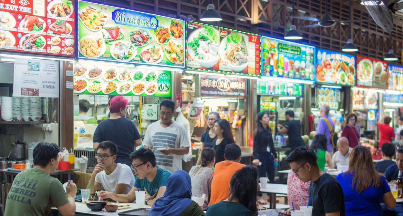 Inside Newton Food Centre showing the rows of hawker stalls and people eating[Photo: Shutterstock]