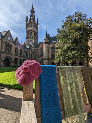 Knitwear draped on a bench on University of Glasgow campus