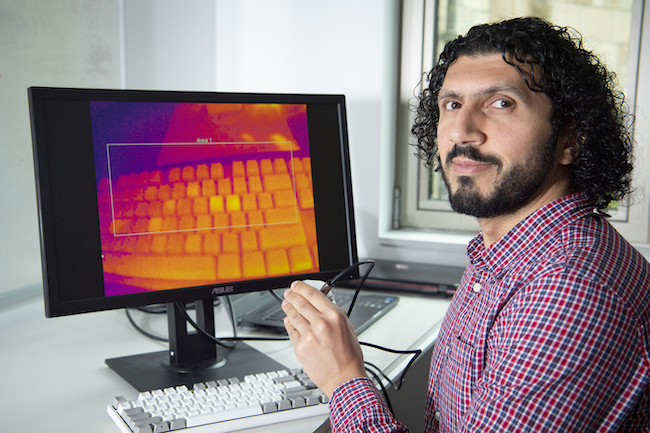 Dr Mohamed Khamis of the School of Computing Science demonstrates using a thermal camera on a computer keyboard