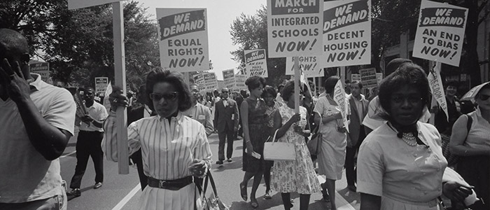 Photo by Library of Congress on Unsplash: Civil rights march on Washington, D.C. Film negative by photographer Warren K. Leffler, 1963. From the U.S. News & World Report Collection. Library of Congress Prints & Photographs Division.     Photograph shows a procession of African Americans carrying signs for equal rights, integrated schools, decent housing, and an end to bias.    