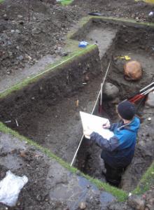 Paul Murtugh excavating a stream bed rich in archaeological material under the Parade, Fort William