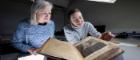 Lleft to right: Julie Gardham, Senior Assistant Librarian, and Keira McKee, Book Conservator, with the University of Glasgow’s First Folio. Credit Martin Shields
