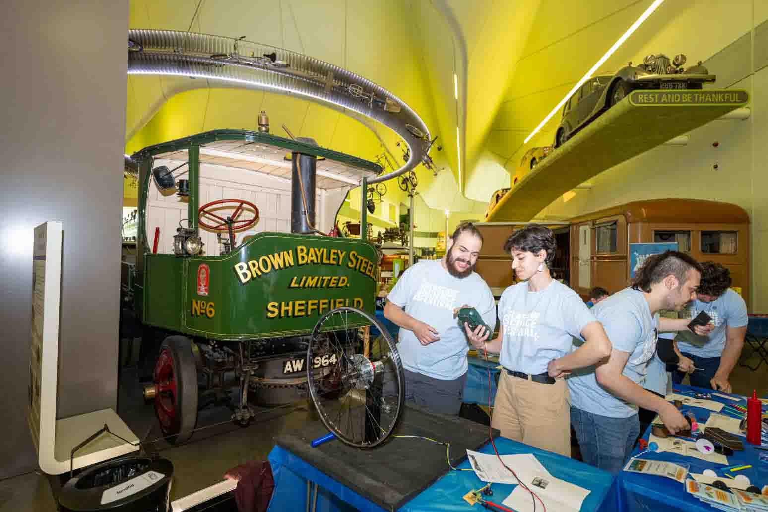 Photograph showing 2 GSF in Action students in the Riverside Museum with a wheel used as a Dynamo. 