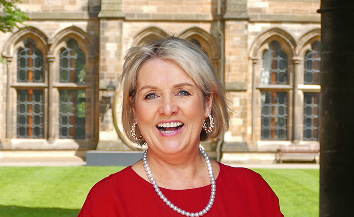 Professor Eleanor Shaw, Head of Adam Smith Business School, standing in the cloisters, University of Glasgow