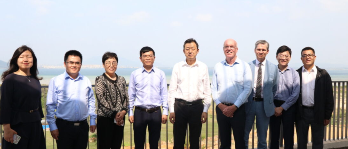 Deans David Young and Robert Partridge stand with group of senior colleagues at Hainan Campus