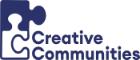 A logo which features the words Creative Communities and two jigsaw pieces one of which is an outline and the other fully filled in 