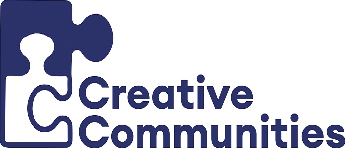 A logo which features the words Creative Communities and two jigsaw pieces one of which is an outline and the other fully filled in