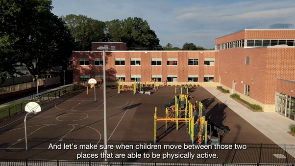 An aerial view of a playground in front of a school building.