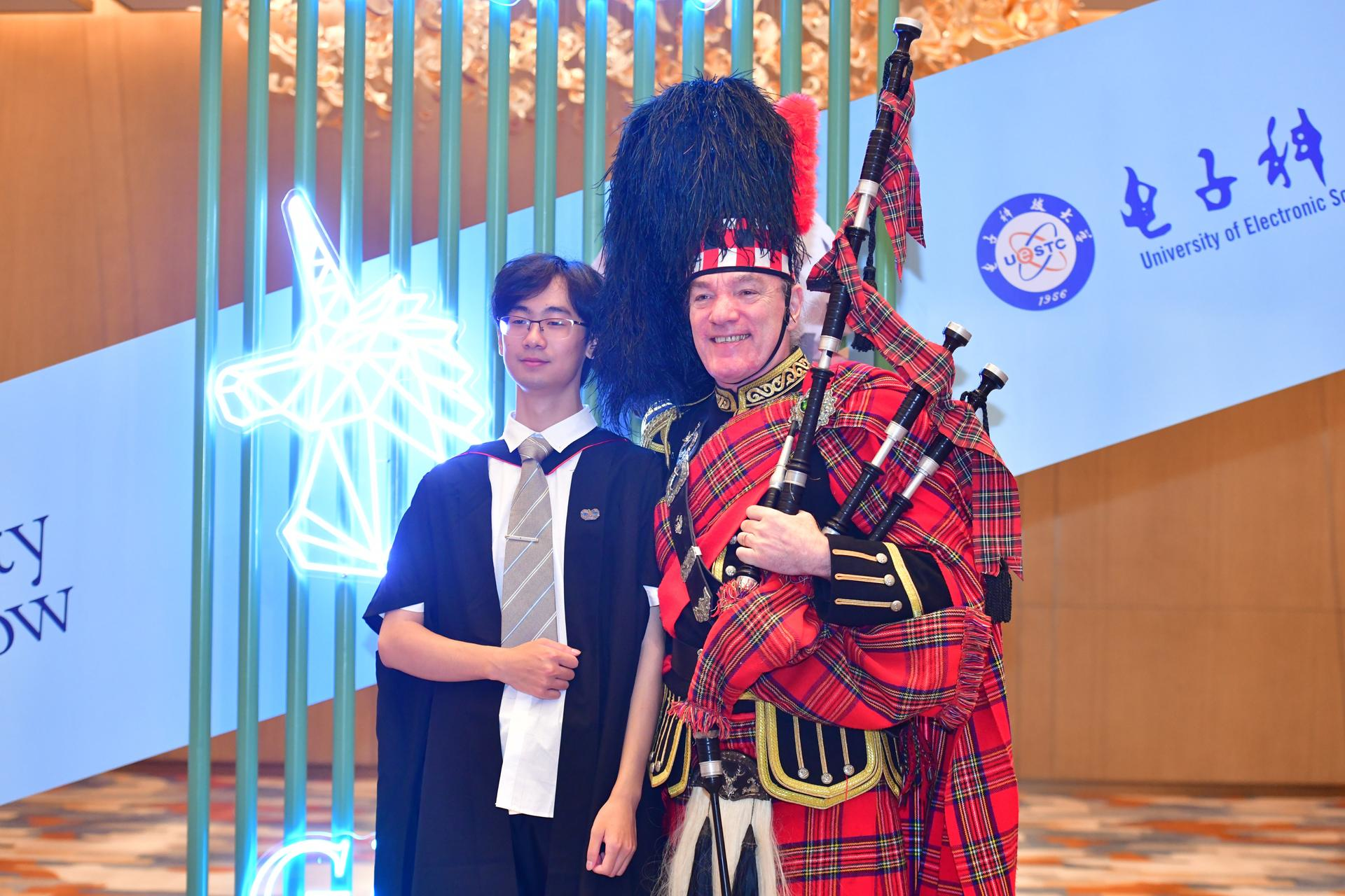 Bagpiper with student at Chengdu graduation