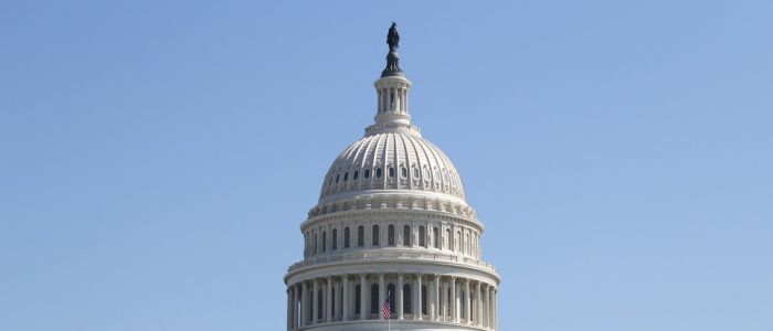 The dome of the US Capitol against a blue sky