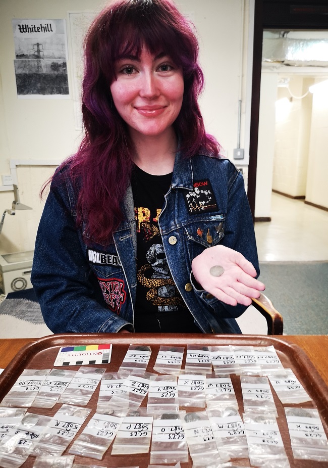 Lucy Ankers, who discovered the hoard, examining the coins in a lab at the University of Glasgow. Credit Gareth Beale 