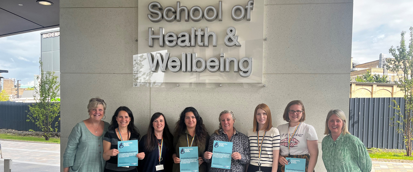 Photo of SHW staff standing outside the Clarice Pears building receiving Breastfeeding Friendly Scheme certificates in September 2023