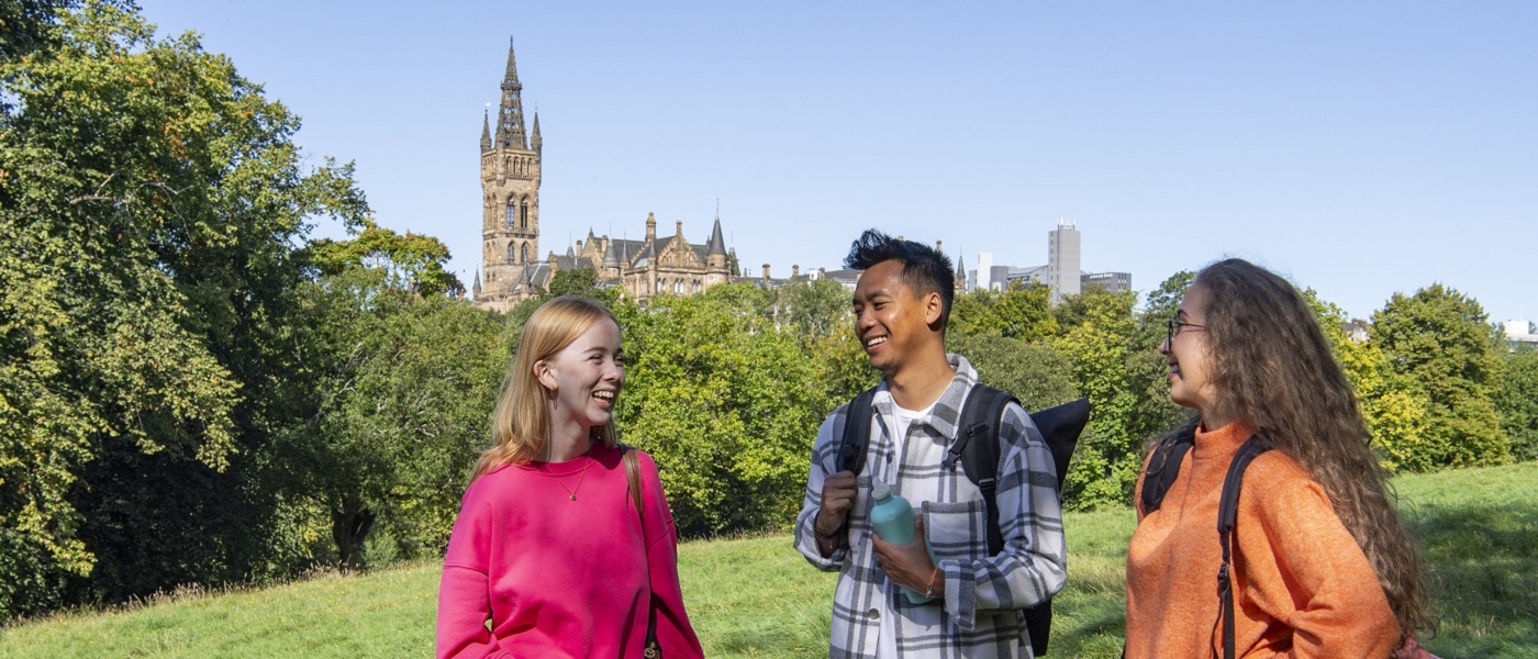 Photo of students in Kelvingrove Park on a sunny day with the tower in the background