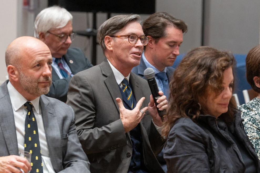 Person with the microphone asking a question behind is her a person standing Source: Charlotte Morris