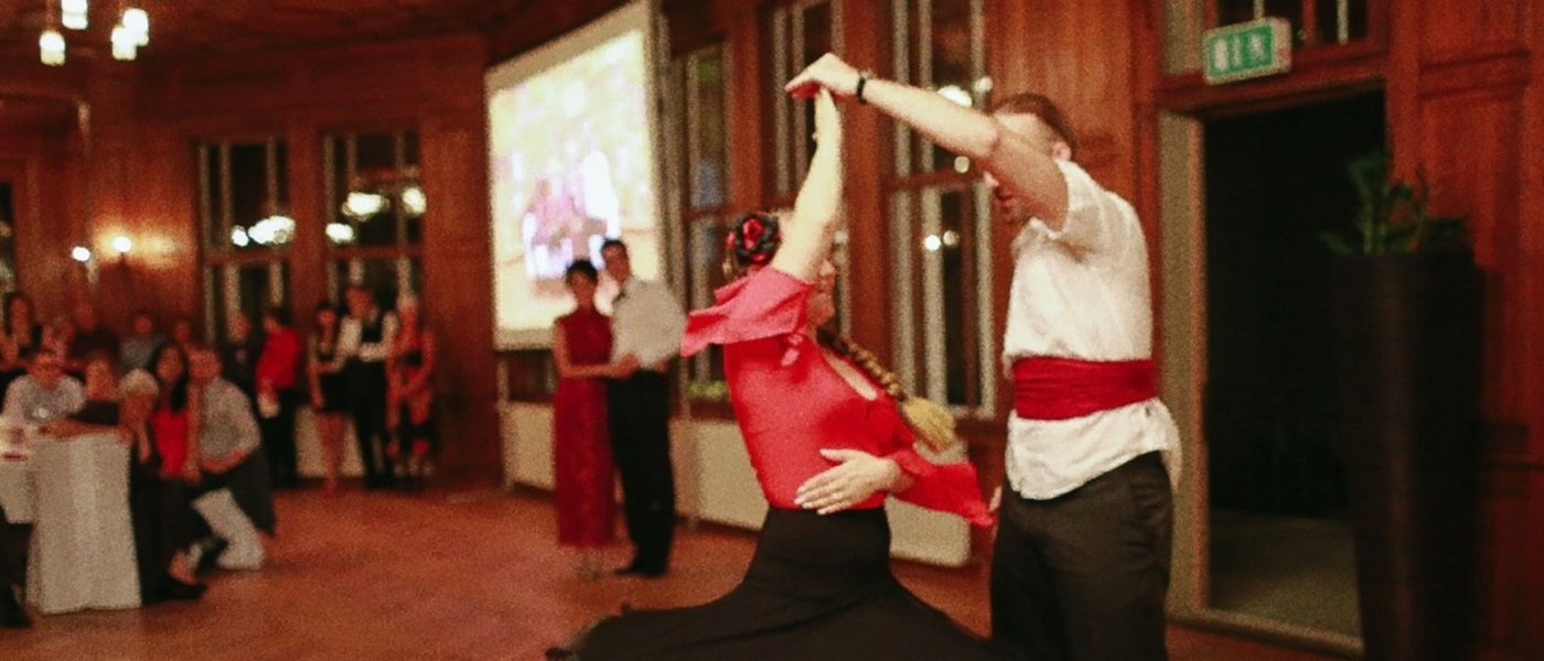 Photo of 2 people dancing in colourful costumes