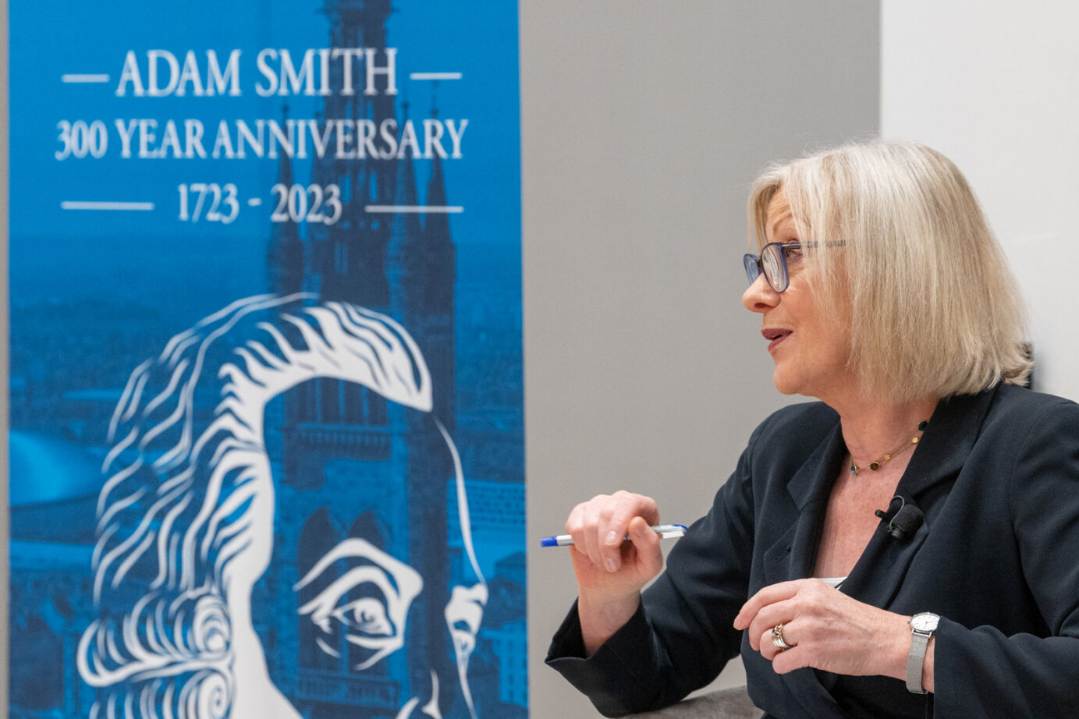 Sara Carter Speaking with the Adam Smith 300 banner behind her Source: Charlotte Morris